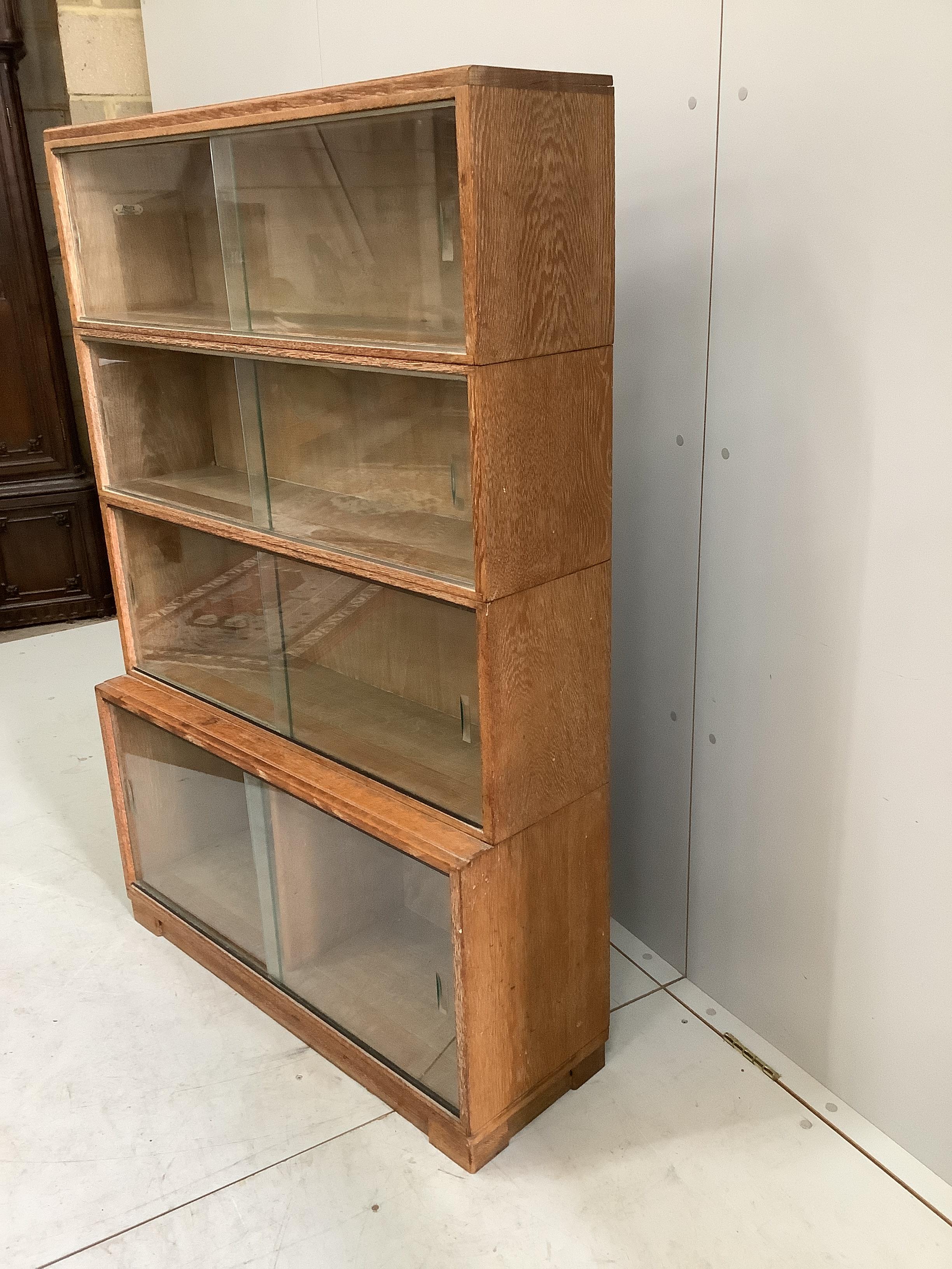 A Minty four section oak glazed bookcase, width 89cm, depth 30cm, height 134cm